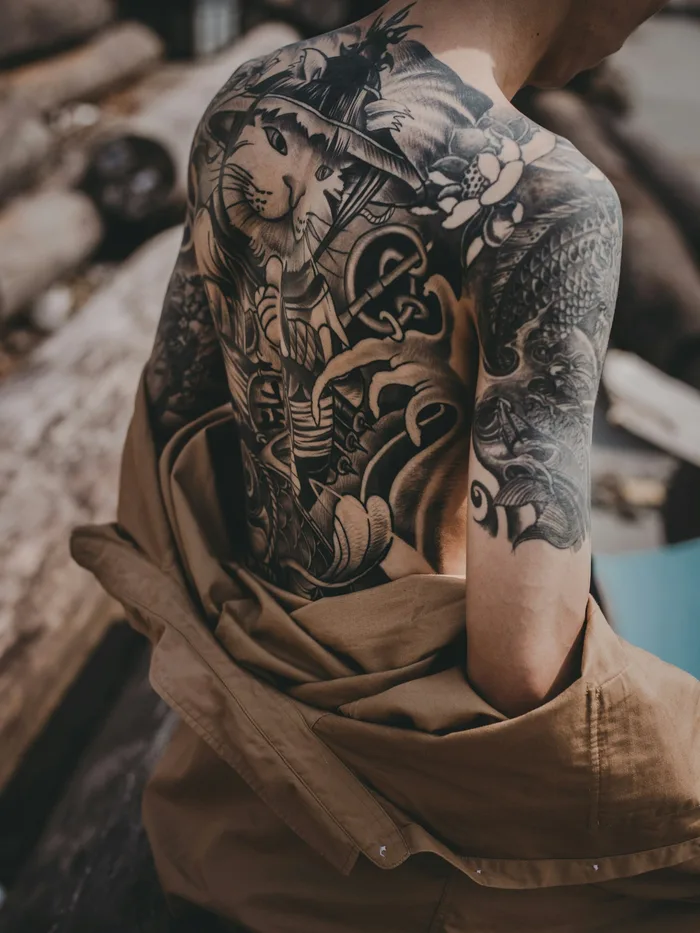 Black and grey blackwork back and shoulder piece with intricate linework