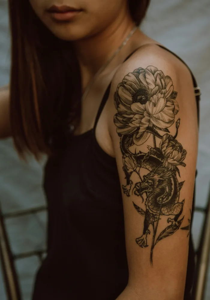 Fine line botanical tattoo with delicate shading on a forearm