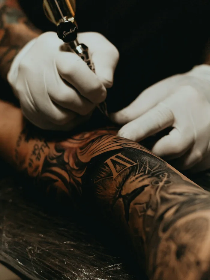 Colour sleeve in progress, saturated illustrative work on the lower leg