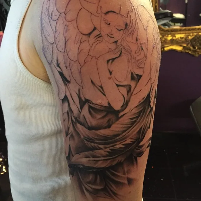 Illustrative black and grey angel half-sleeve with soft shading