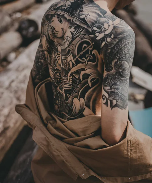 Black and grey blackwork back and shoulder piece by Kai Nakamura